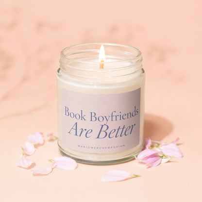 Candle with lit wick, "Book Boyfriends Are Better" text, and pink petals.