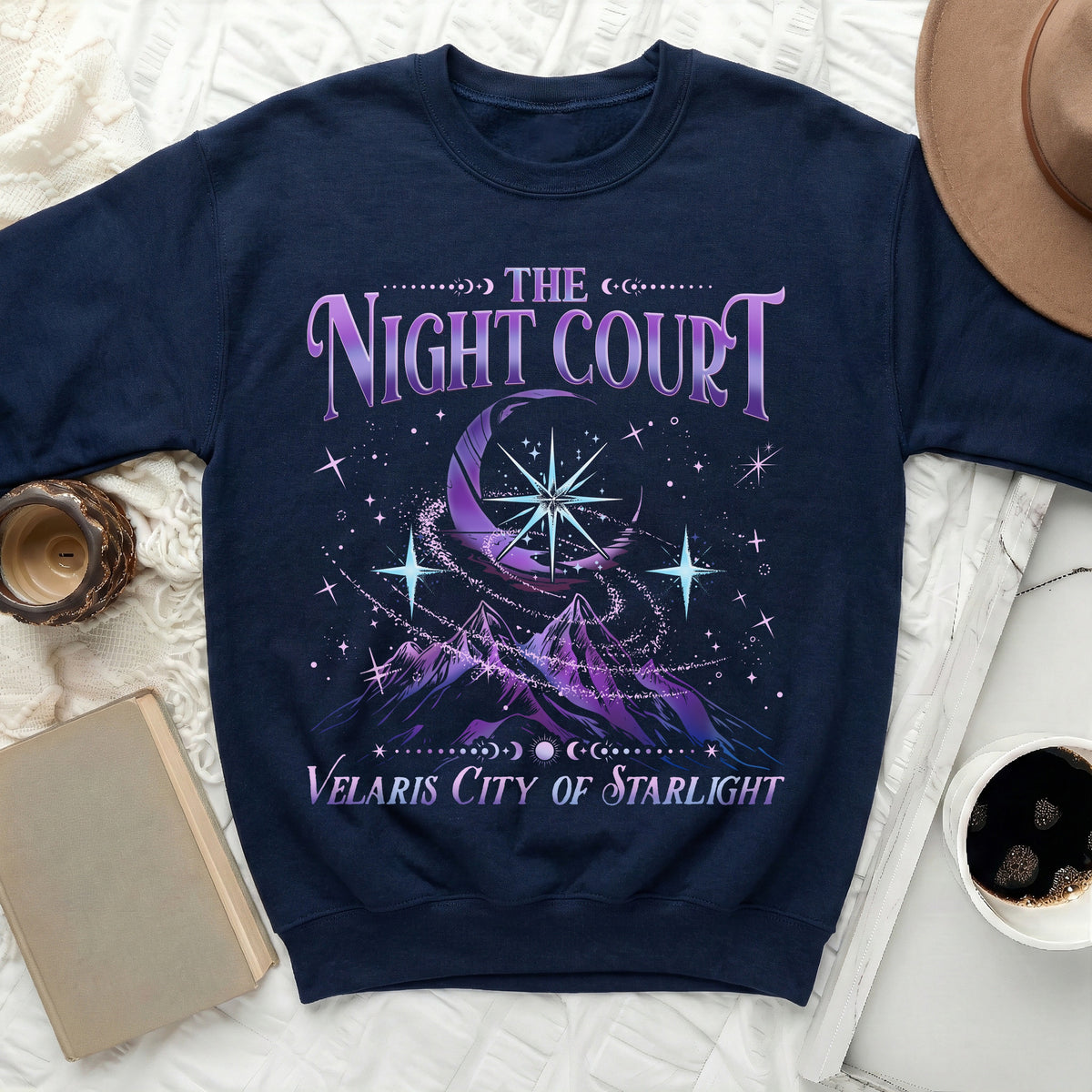 Navy sweatshirt with "The Night Court Velaris City of Starlight" text and celestial design.