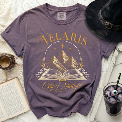 Purple t-shirt with "Velaris City of Starlight" graphic featuring mountains and an open book.