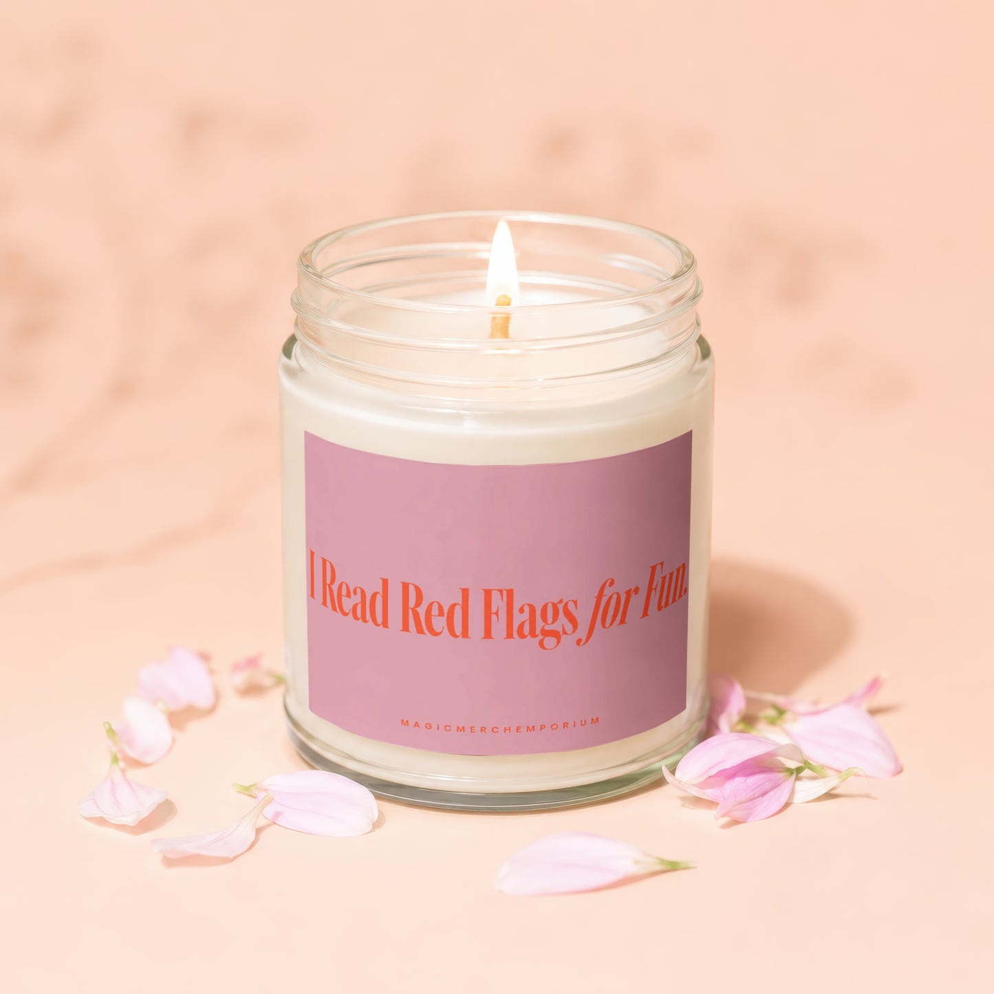Candle with pink label reading "I Read Red Flags for Fun".