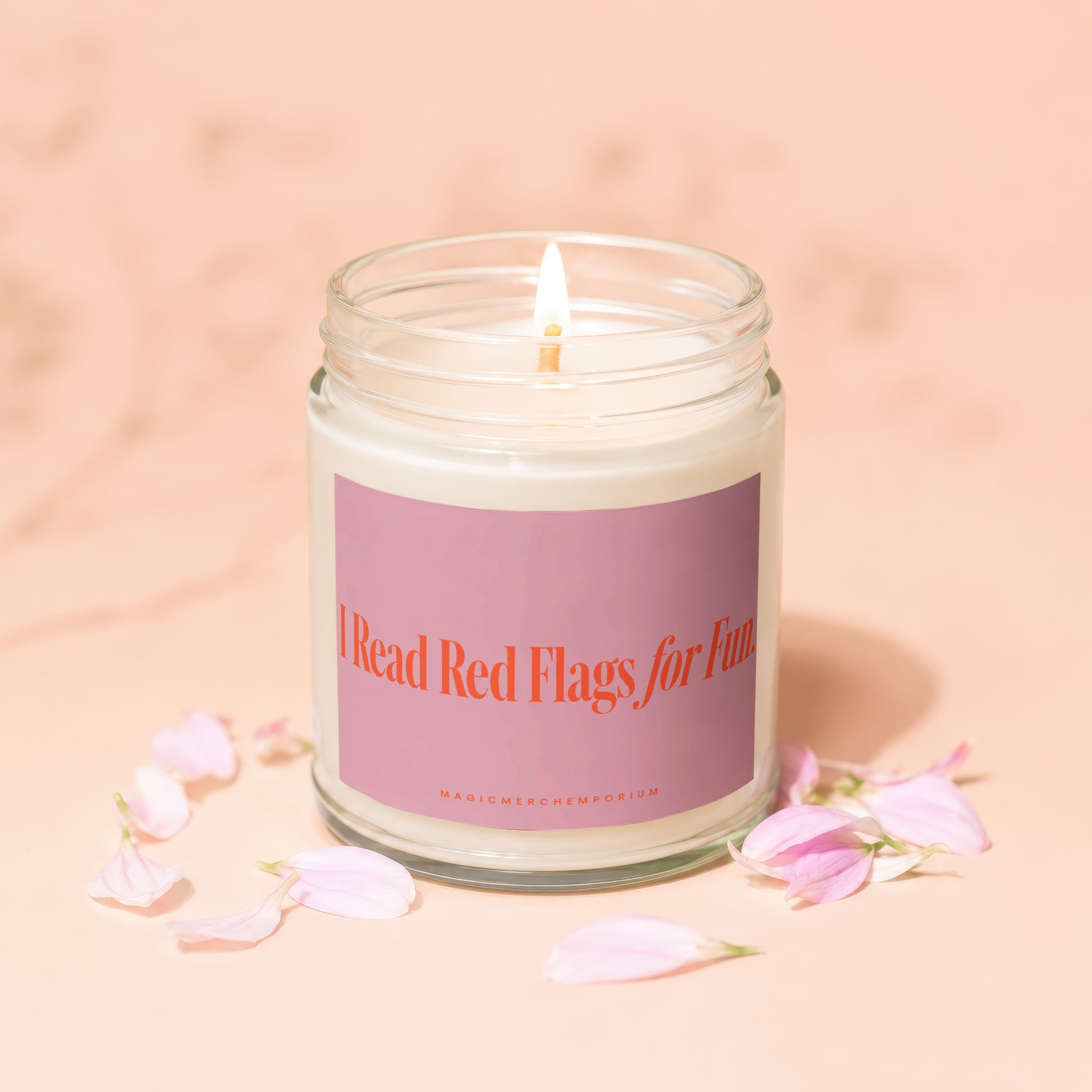 Candle with pink label reading "I Read Red Flags for Fun".