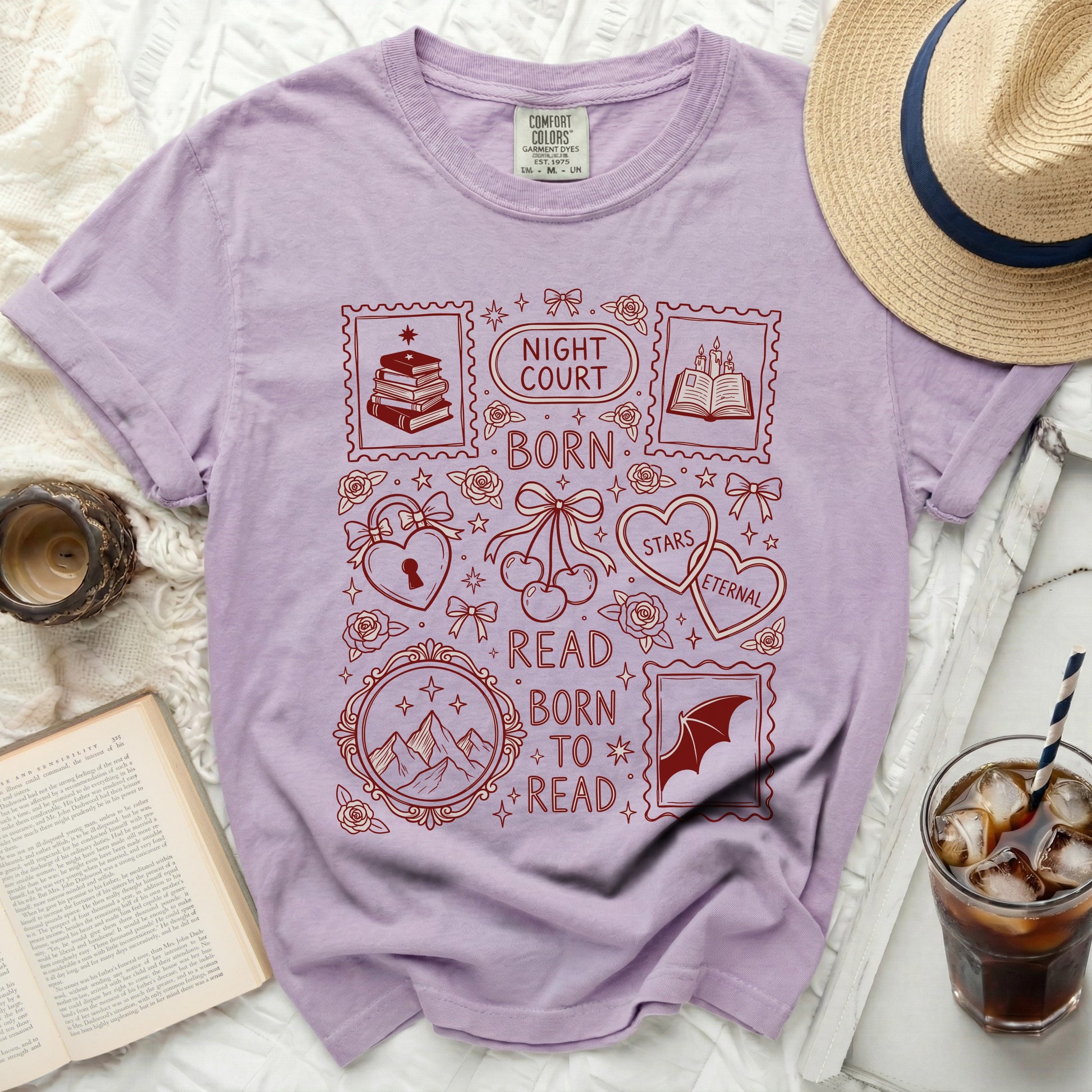 Purple t-shirt with red "Night Court Born to Read" stamp design and book motifs.
