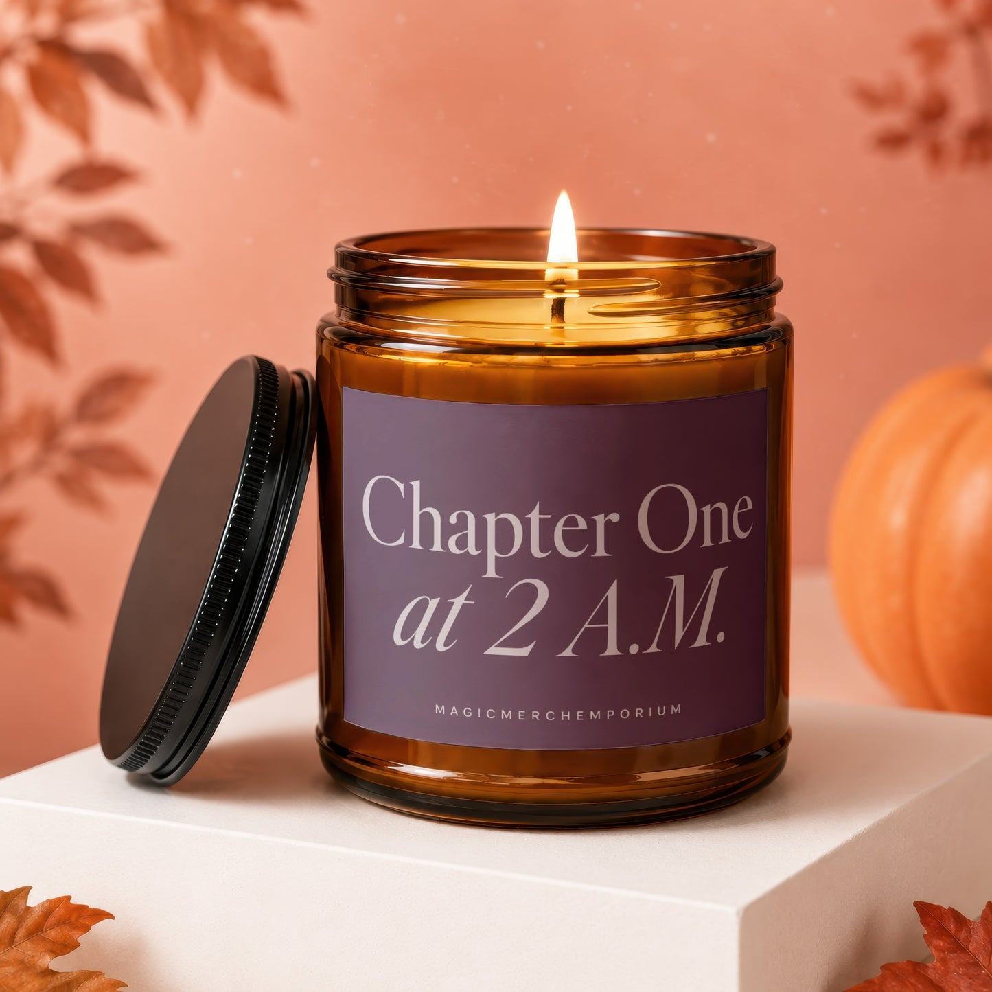 Amber jar candle with lit wick reads "Chapter One at 2 A.M."