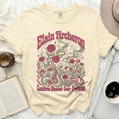 Cream t-shirt with "Elain Archeron Cauldron Blessed Seer Prythian" floral design.