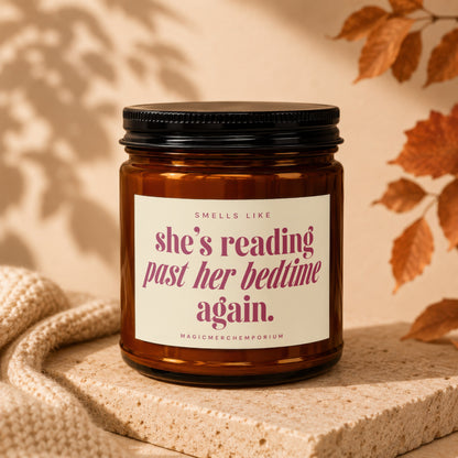 Amber candle with text "she's reading past her bedtime again."