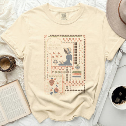 Cream t-shirt with "Pride and Prejudice" embroidery of a woman and roses.