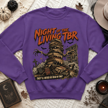 Purple sweatshirt with "Night of the Living TBR" text and a stack of sentient books.