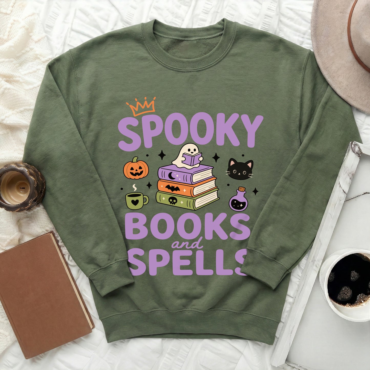 Green sweatshirt with spooky books and spells Halloween graphic design.