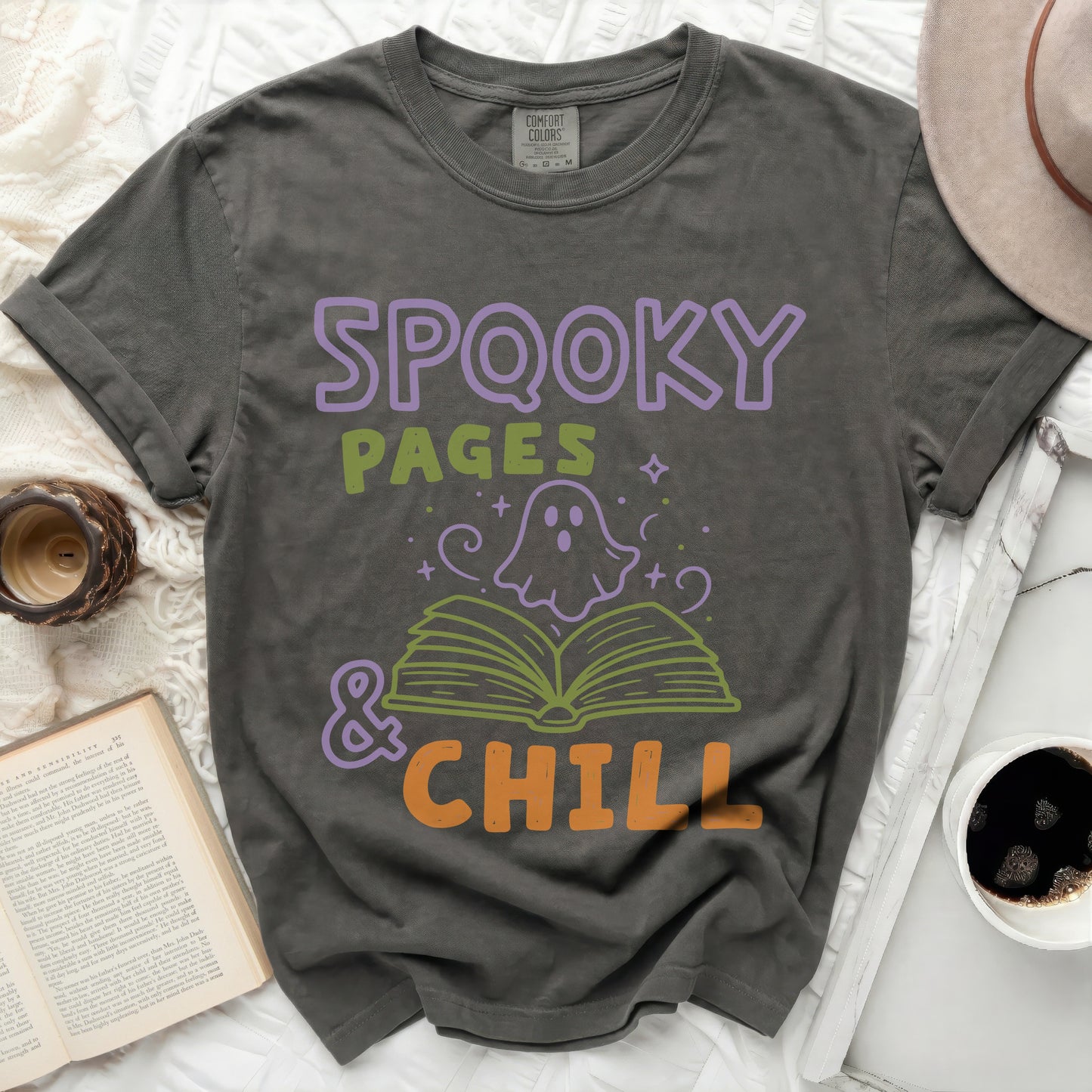 Spooky Pages and Chill graphic tee with ghost and open book.