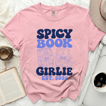 Pink t-shirt with "Spicy Book Girlie Est. 2026" and book illustrations.