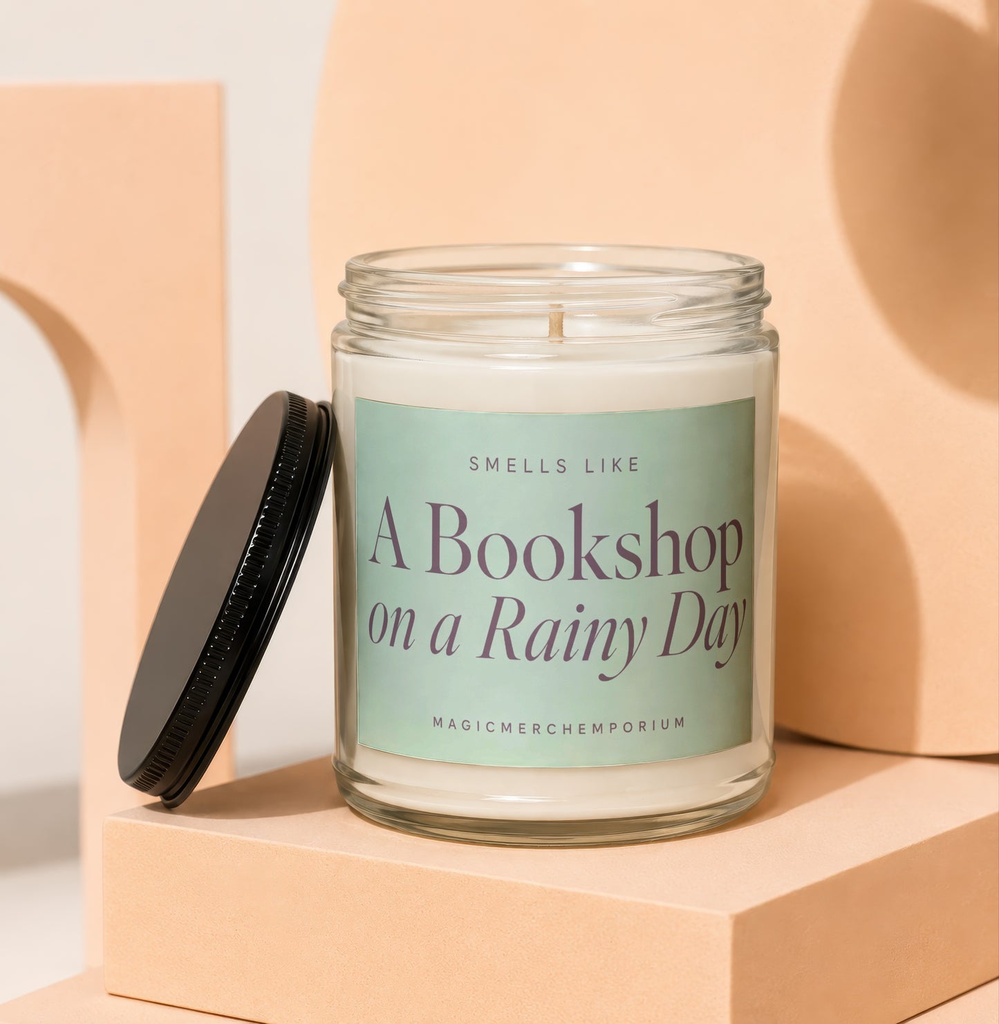 Jar candle labeled "A Bookshop on a Rainy Day" with black lid.