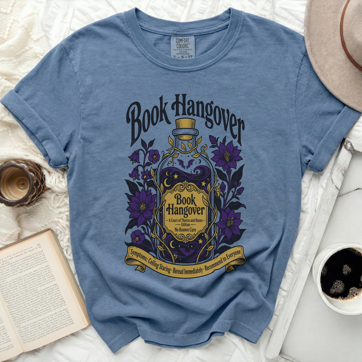 Blue t-shirt with "Book Hangover" text and potion bottle graphic.