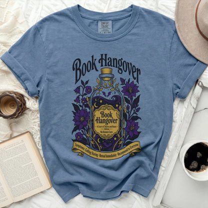 Blue t-shirt with "Book Hangover" text and potion bottle graphic.