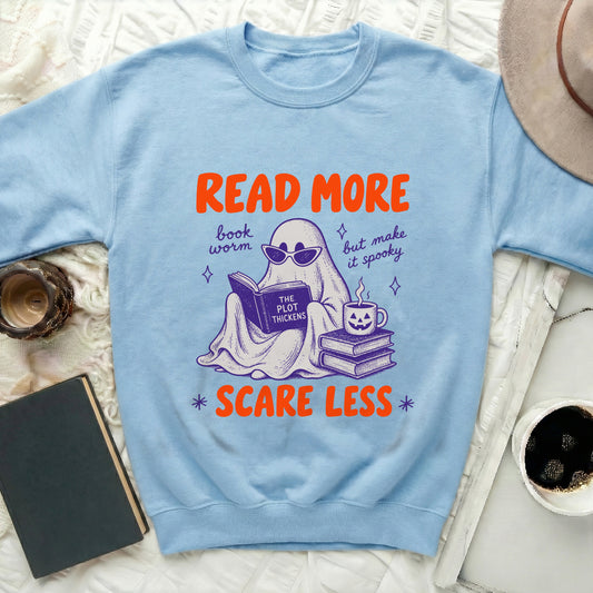Light blue sweatshirt with "Read More, book worm, but make it spooky, Scare Less" text and ghost graphic.
