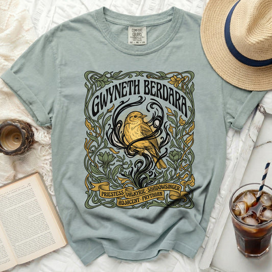 T-shirt with a bird and floral design, text reads Gwyneth Berdara.
