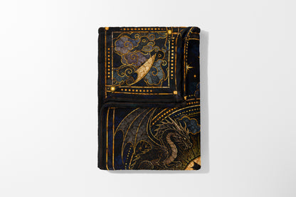 Black blanket with a dragon and celestial design in gold and blue.