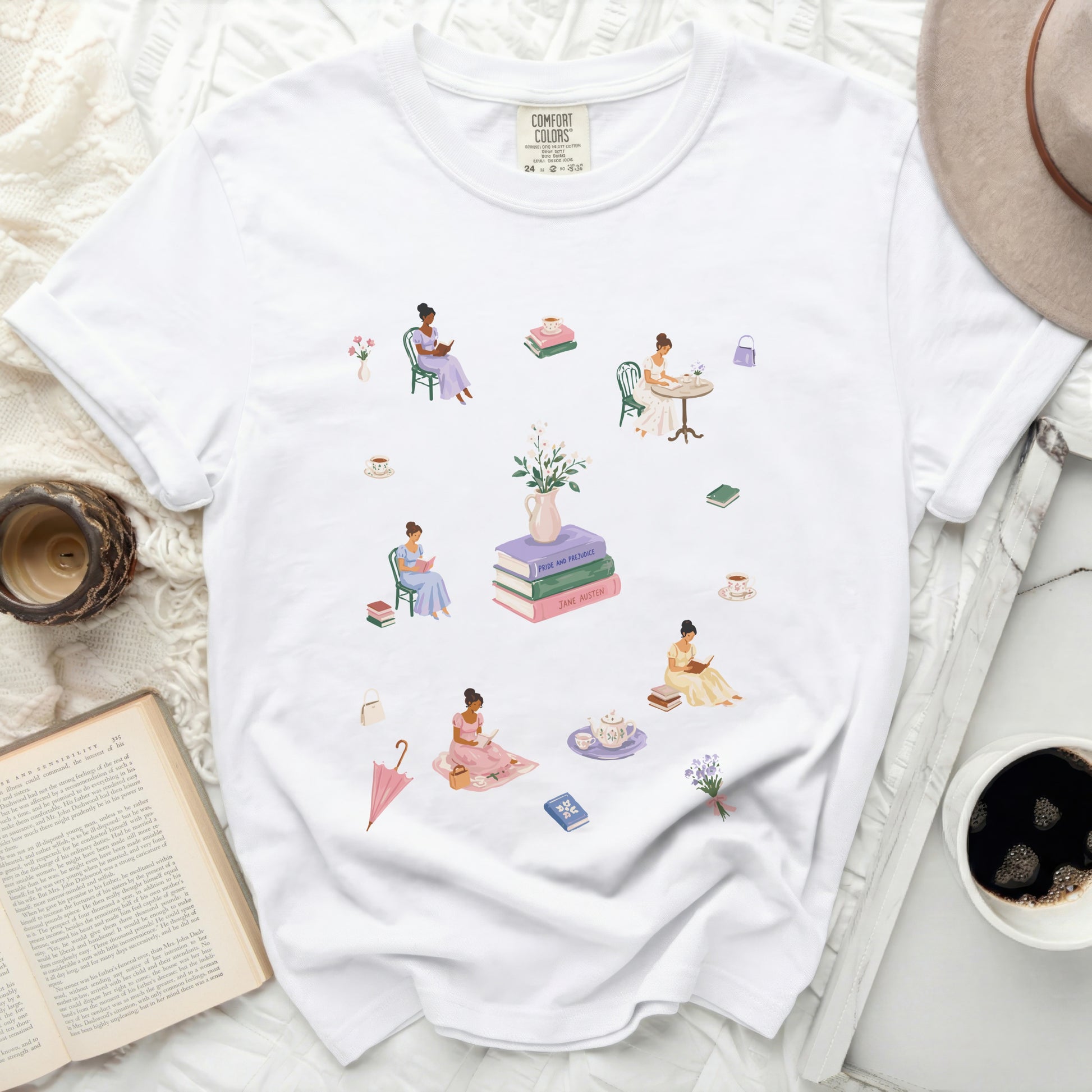 White t-shirt with illustrations of women reading and drinking tea.