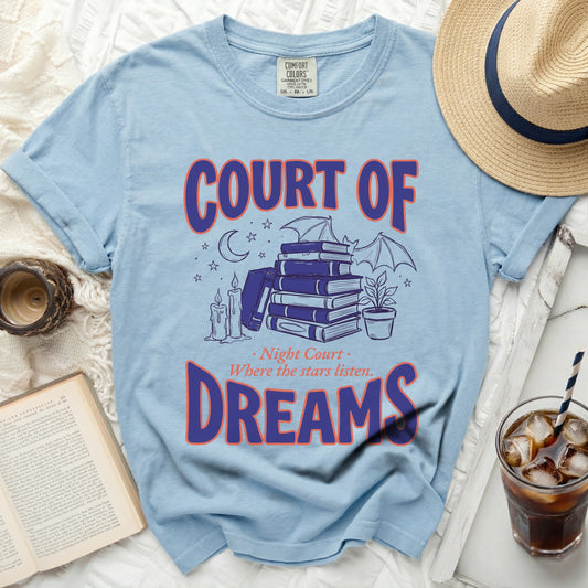 Light blue t-shirt with "COURT OF DREAMS" and a drawing of books, candles, and a bat.