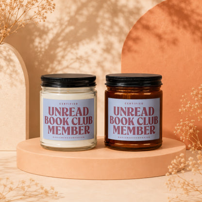 Two candles with "Unread Book Club Member" labels on a display stand.