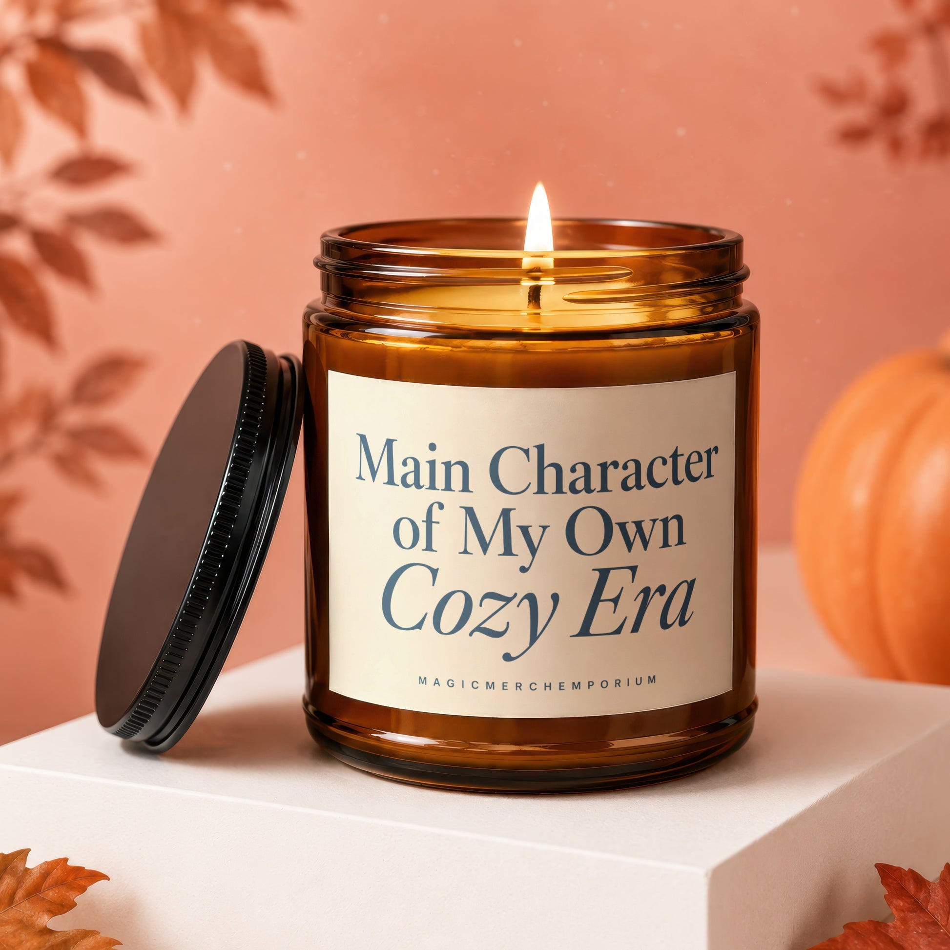 Burning amber candle with lid off, reading "Main Character of My Own Cozy Era".