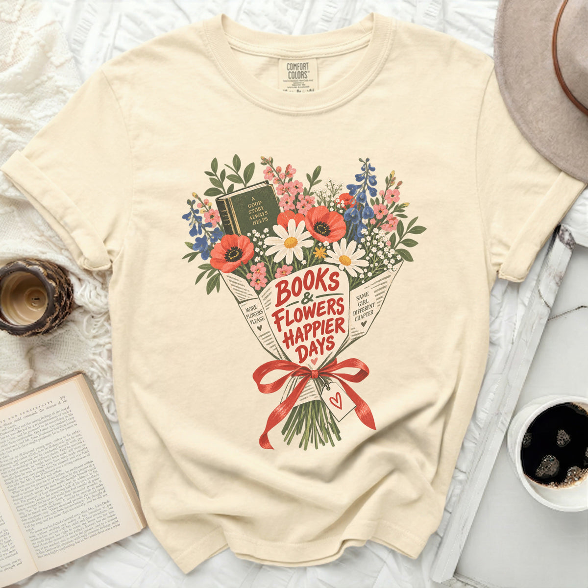 Cream t-shirt with "Books & Flowers Happier Days" floral bouquet graphic.
