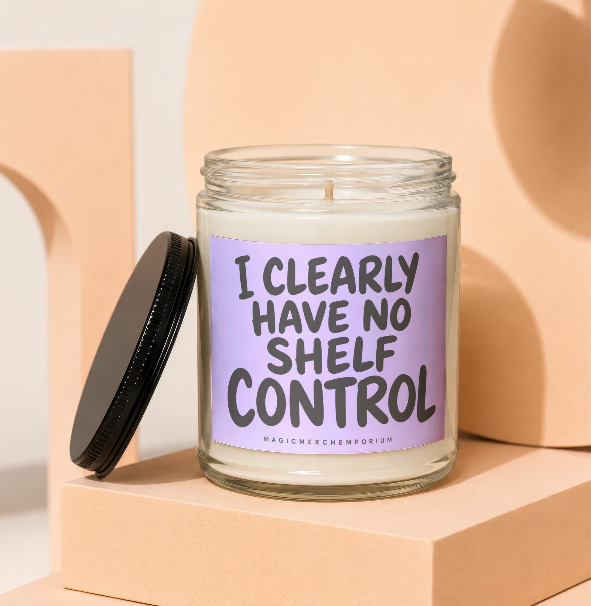 Glass candle with black lid and "I CLEARLY HAVE NO SHELF CONTROL" text.