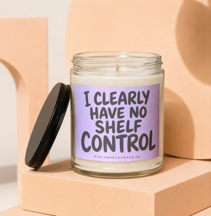 Glass candle with black lid and "I CLEARLY HAVE NO SHELF CONTROL" text.