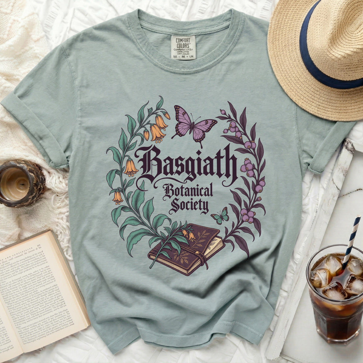 Light green t-shirt with "Basgiath Botanical Society" floral and butterfly graphic.