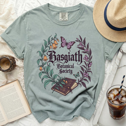 Light green t-shirt with "Basgiath Botanical Society" floral and butterfly graphic.