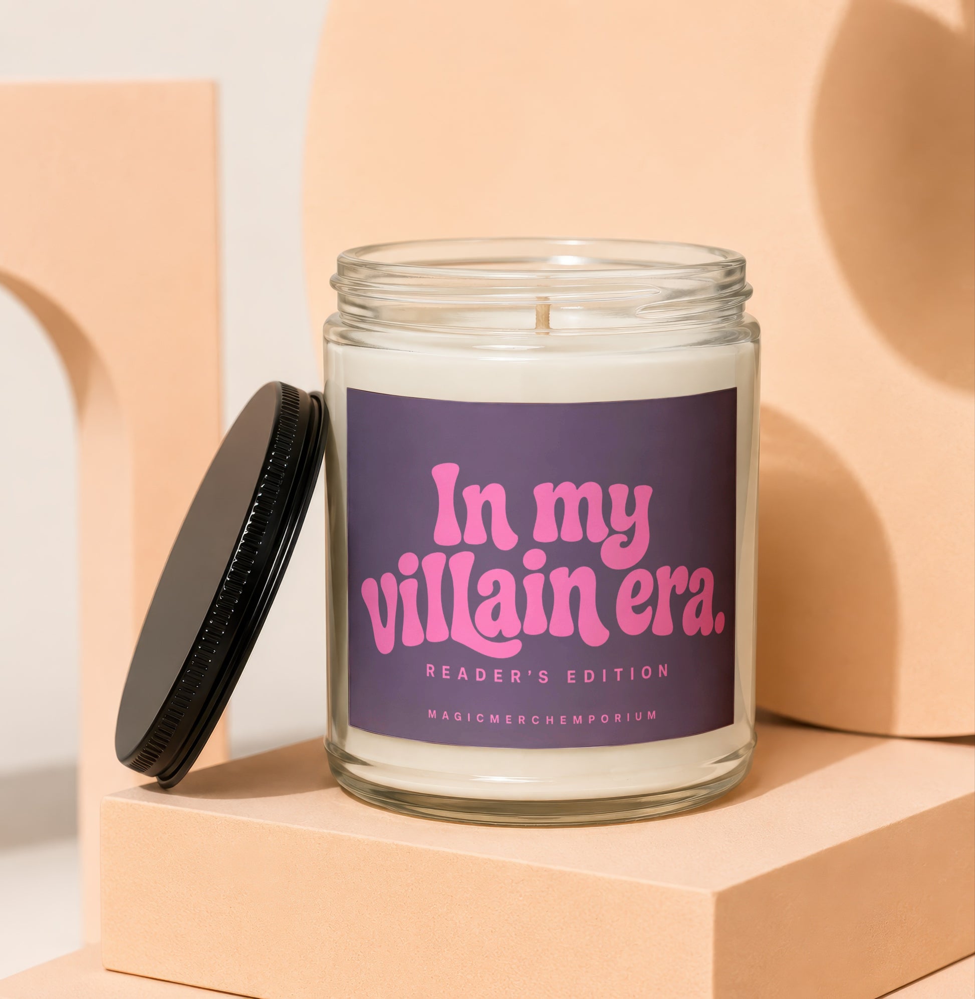 Glass candle with "In My Villain Era. Reader's Edition" on purple label.