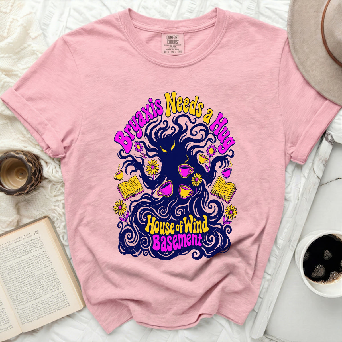 Pink Comfort Colors shirt with "Bryaxis Needs a Hug" and "House of Wind Basement" graphic.