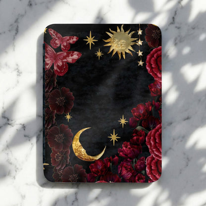 Dark floral design with butterflies, sun, moon, and stars on a textured background.