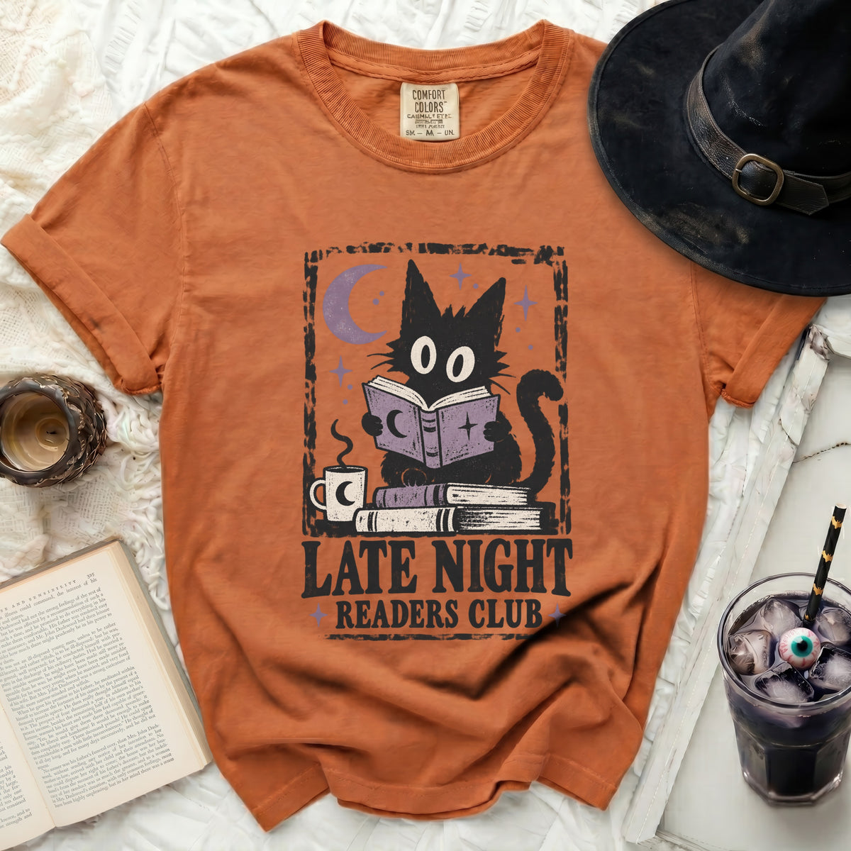Orange t-shirt with black cat reading a book, text "Late Night Readers Club".