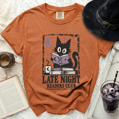 Orange t-shirt with black cat reading a book, text "Late Night Readers Club".