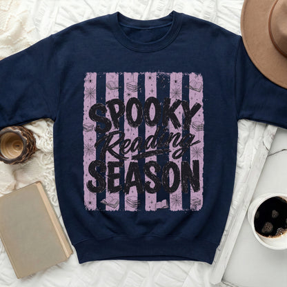 Navy sweatshirt with "Spooky Reading Season" text on a striped background.