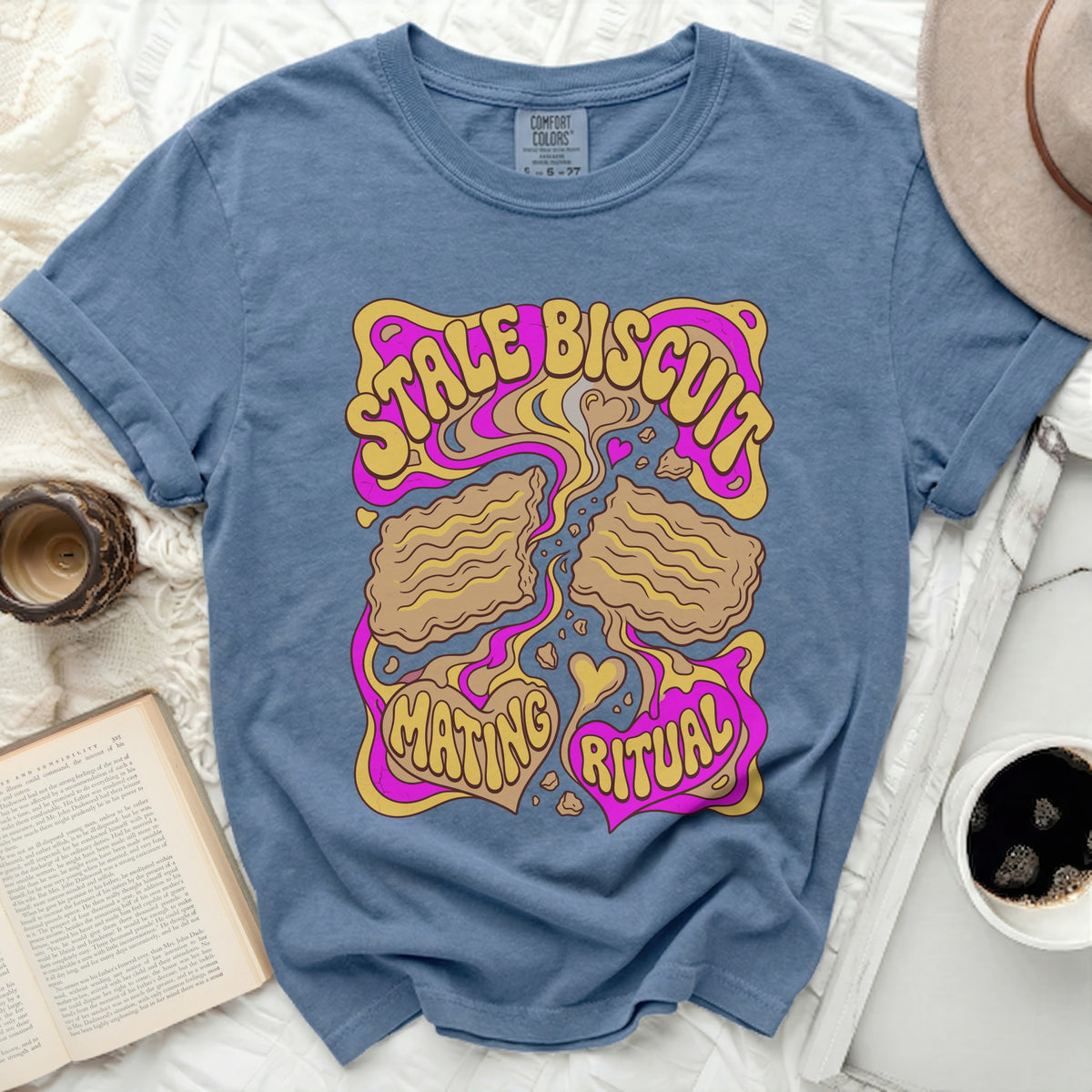 Stale Biscuit Mating Ritual graphic on a blue t-shirt.