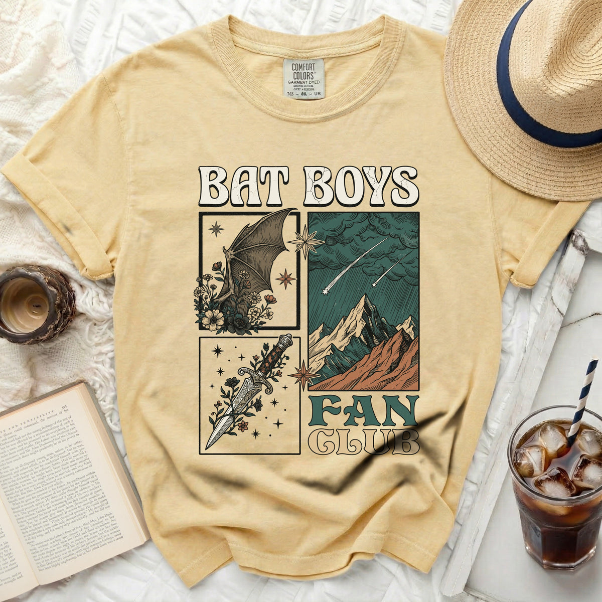 Yellow t-shirt with "Bat Boys Fan Club" graphic featuring a bat, dagger, and mountains.