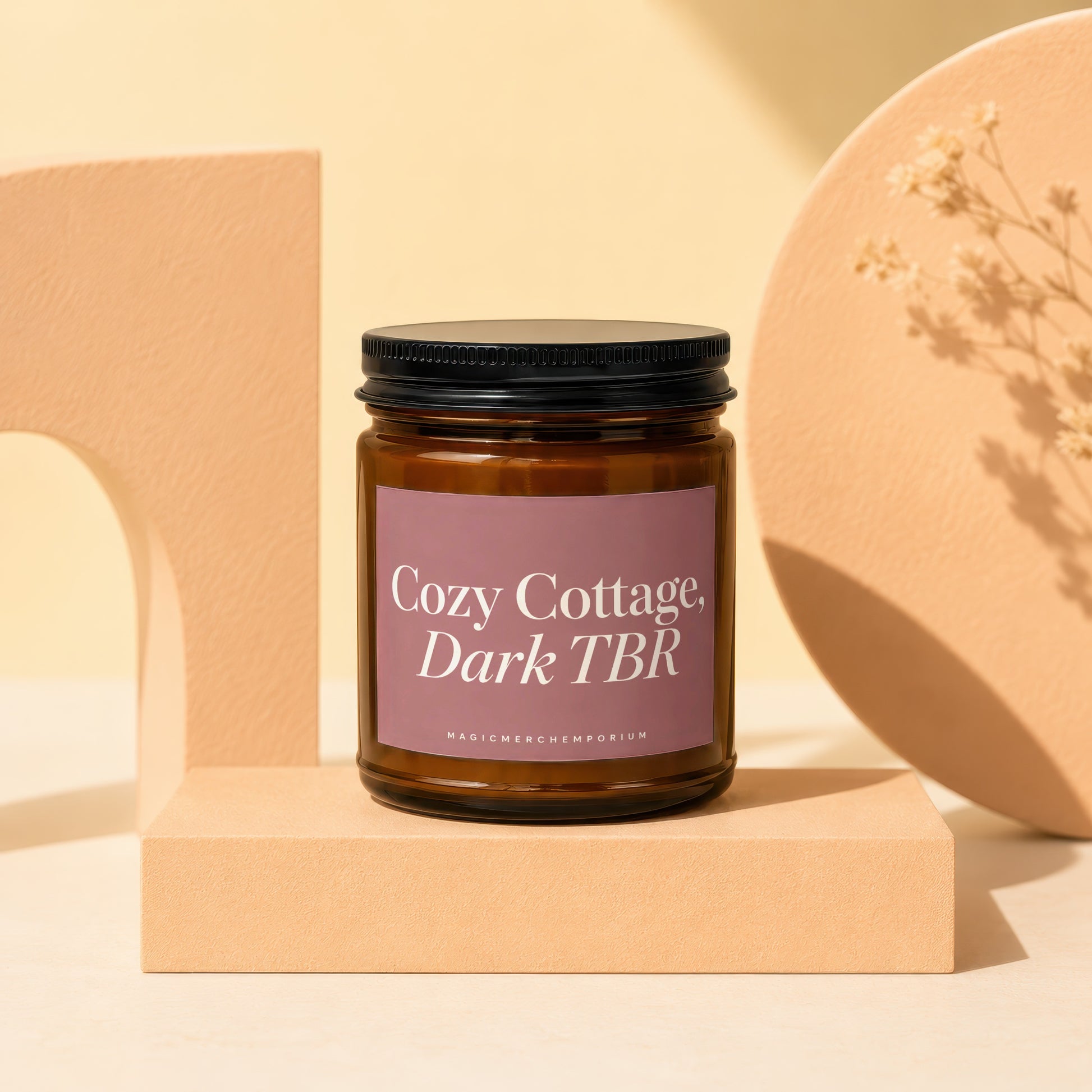 Amber jar candle labeled "Cozy Cottage, Dark TBR" from MagicMerchEmporium.