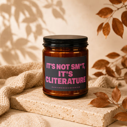 Amber jar candle with pink text "IT'S NOT SM*T, IT'S CLITERATURE" and "MAGICMERCHEMPORIUM".