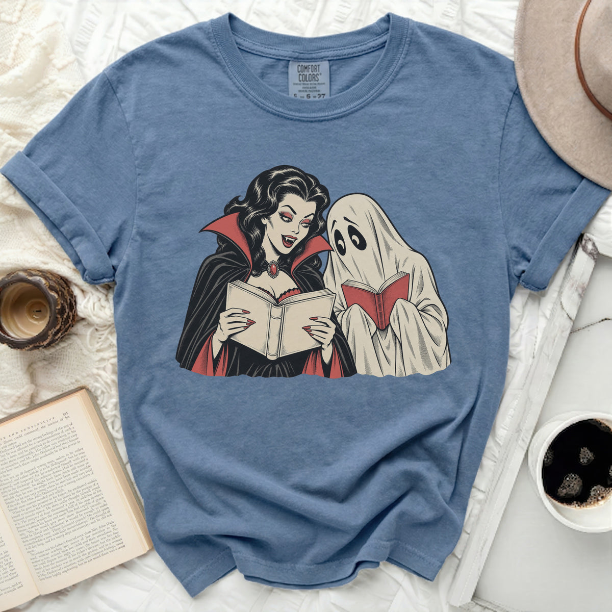 Vampire and ghost reading books on a blue t-shirt.