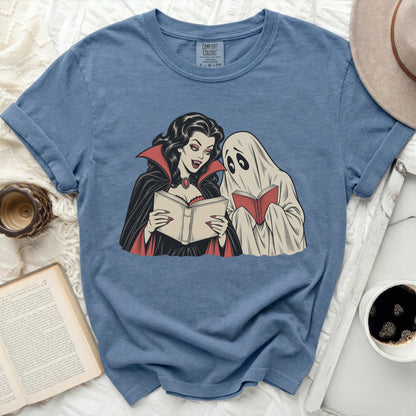 Vampire and ghost reading books on a blue t-shirt.