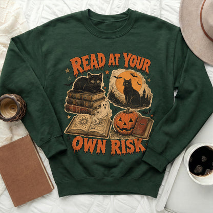 Green sweatshirt with Halloween graphic: cats, books, pumpkin, and bats.