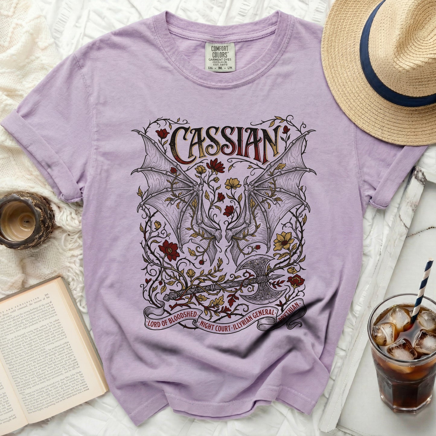 Lilac t-shirt with Cassian design, bat wings, axe, and text.