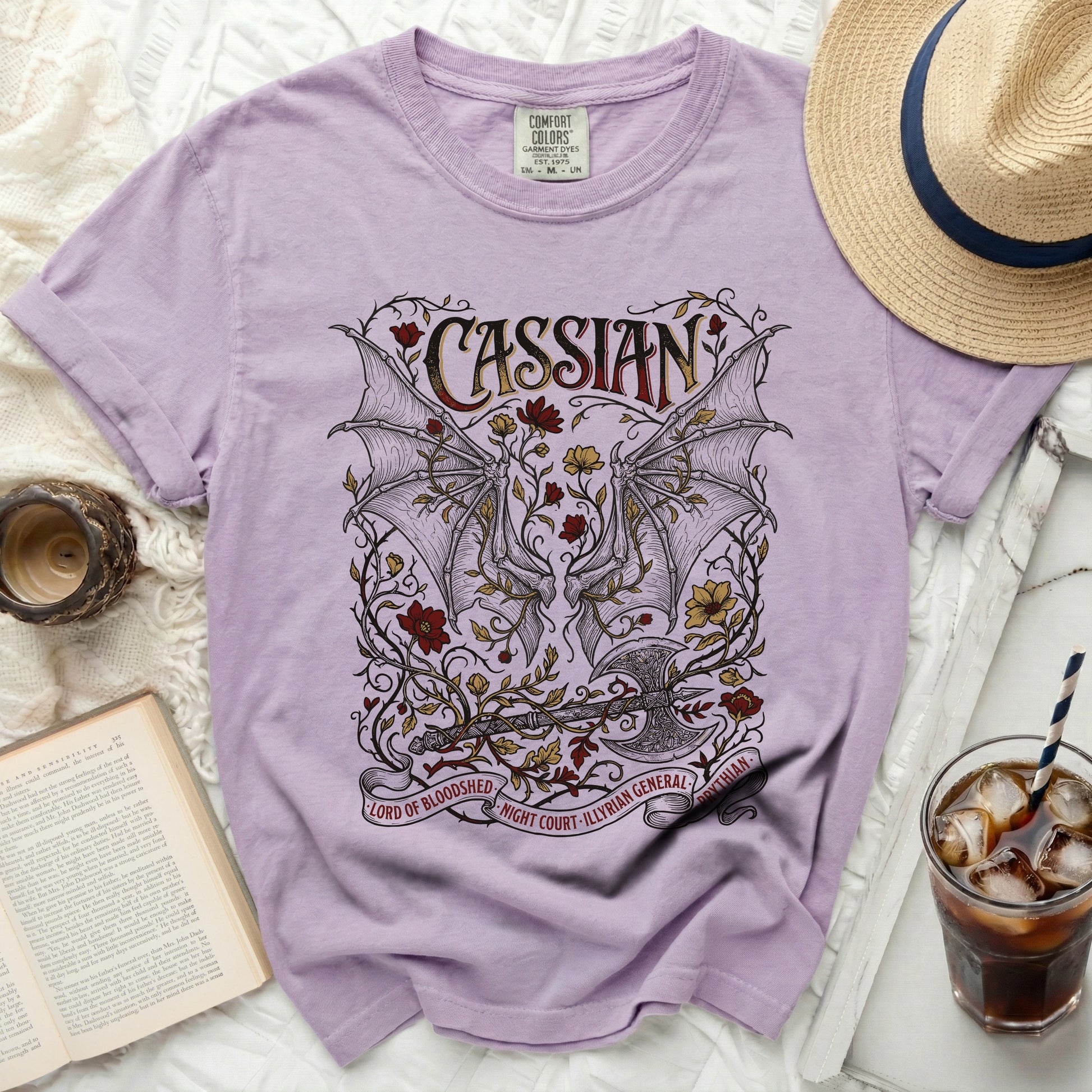 Lilac t-shirt with Cassian design, bat wings, axe, and text.