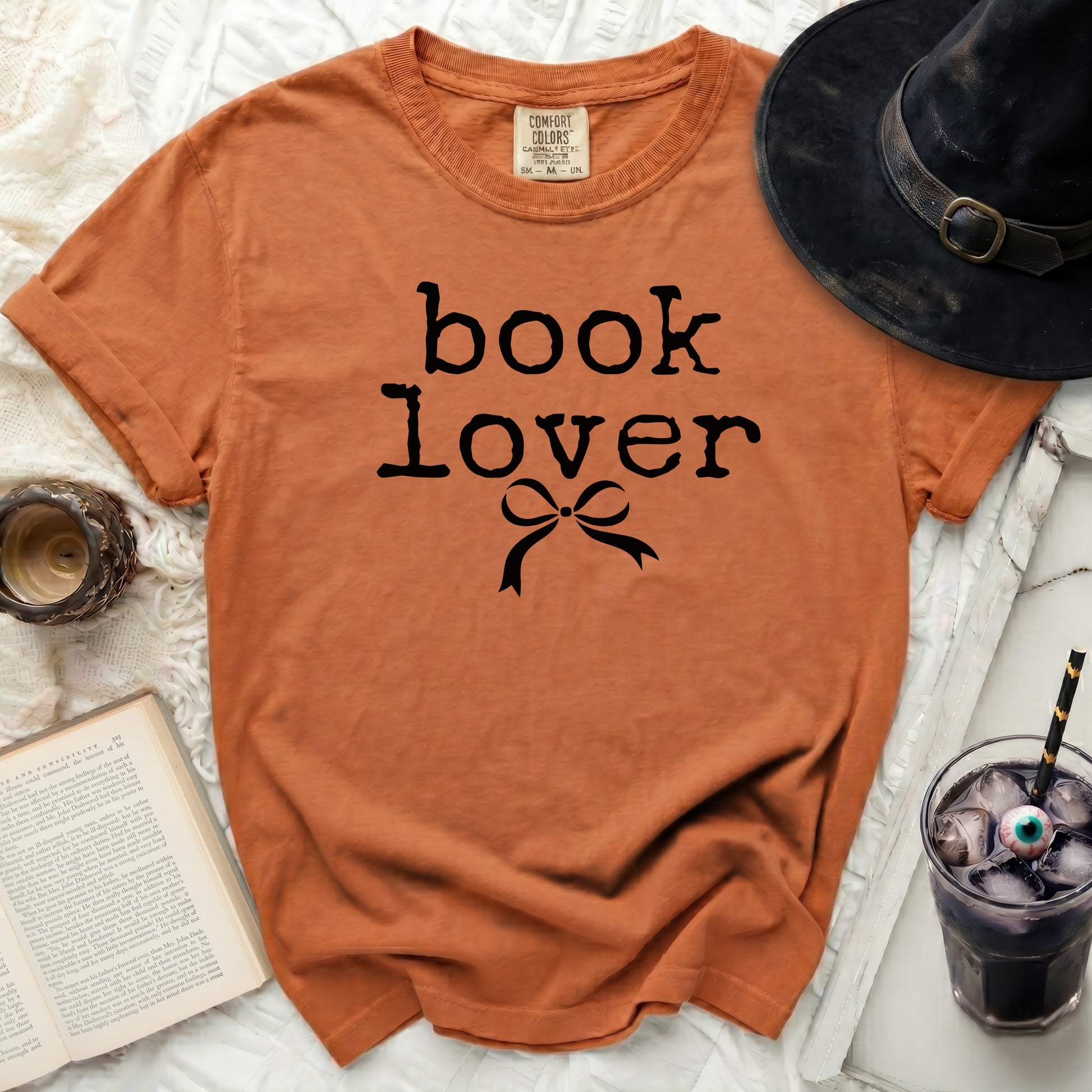 Orange t-shirt with black "book lover" text and bow.