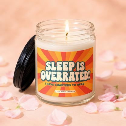 A lit candle in a glass jar with a retro label reading "Sleep is overrated! I have chapters to read".