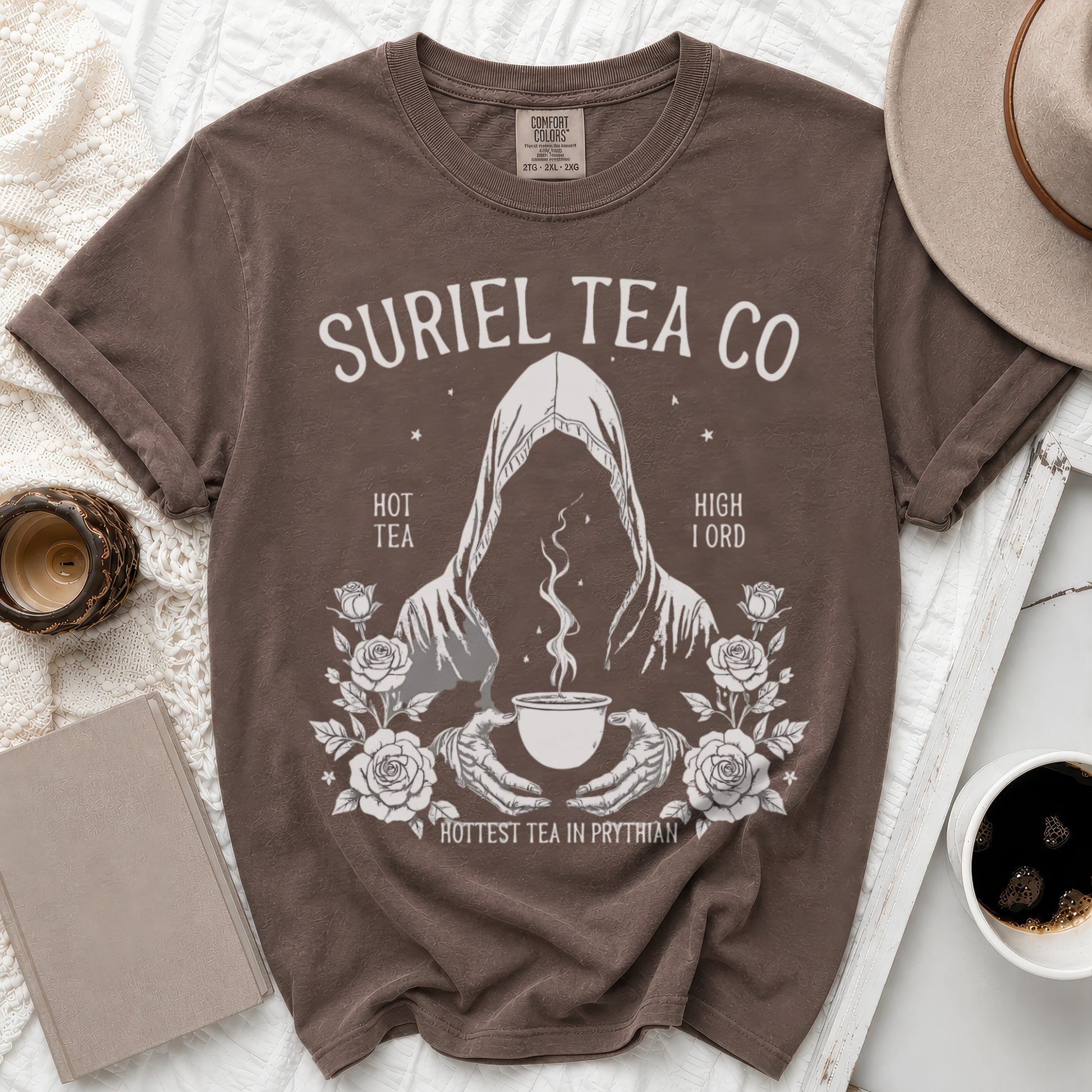 Brown Comfort Colors t-shirt with Suriel Tea Co. graphic featuring a hooded figure and roses.
