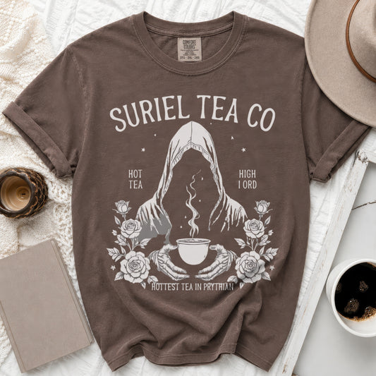 Brown Comfort Colors t-shirt with Suriel Tea Co. graphic featuring a hooded figure and roses.