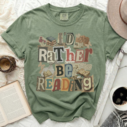 "I'd Rather Be Reading" text design on a green t-shirt with book illustrations.