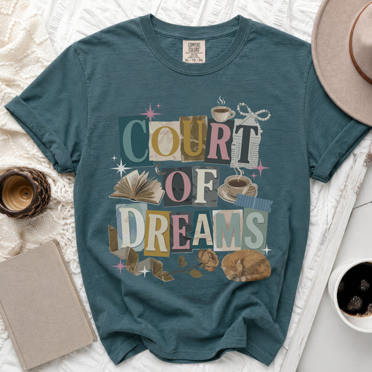 Teal t-shirt with "COURT OF DREAMS" graphic featuring collage elements, a cat, and books.